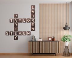 a living room filled with furniture next to a wall mounted scrabble tile sign