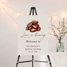 a welcome sign is displayed in front of a white backdrop with string lights and flowers