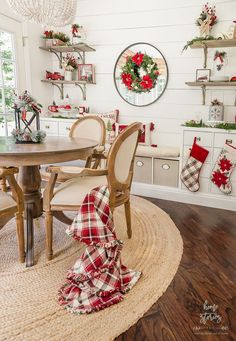 a dining room with christmas decorations on the wall