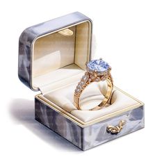 an open box with a ring in it and a diamond on the inside is shown