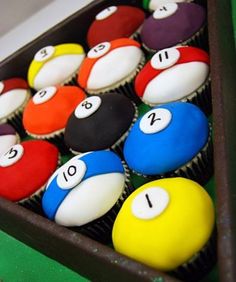 cupcakes with numbers on them sitting in a tray