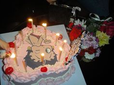 a birthday cake with lit candles on it