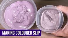 two plastic containers filled with purple cream on top of a wooden table