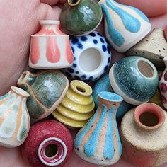 there are many small vases in the hand