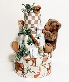 a teddy bear sitting on top of a diaper filled with baby products and toys