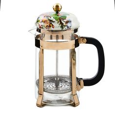 a french press coffee maker with a glass lid and gold trimming on the handle