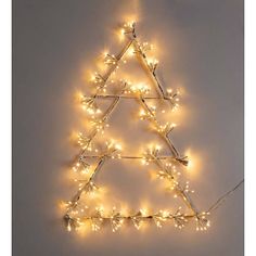 a christmas tree made out of branches with lights on it's sides and the shape of a triangle