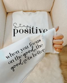 someone is holding up a t - shirt that says positive and when you focus on the good, the good gets better