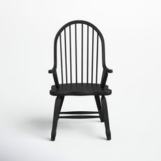 a black wooden chair on a white background with no one in it's seat