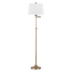 a floor lamp with a white shade on the base and a gold metal pole,