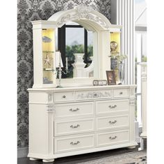 a white dresser and mirror in a room