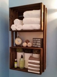 a wooden shelf with towels and other items on it