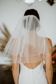 the back of a woman wearing a veil