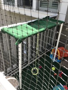 there is a cage with toys in it