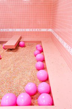 an ice cream parlor with pink balls and sprinkles on the floor,