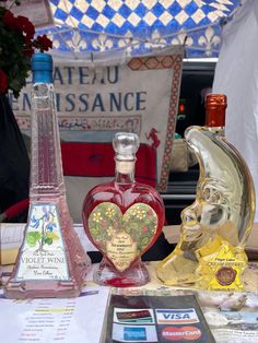 some bottles are sitting on a table with cards and other items in front of them