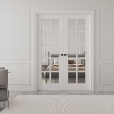 an empty room with two chairs and a bed in the background, there is a white rug on the floor