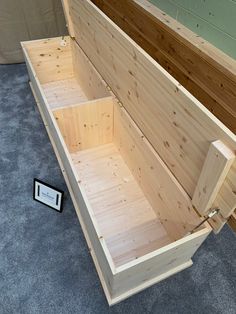 an empty wooden box sitting on the floor