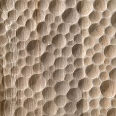 a close up view of the textured fabric on an object that appears to be made out of wood