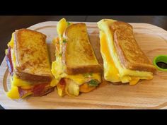 three grilled cheese sandwiches on a cutting board