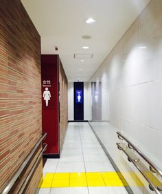 an empty hallway with yellow and white flooring