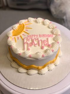 a birthday cake with the words happy birthday rachel on it sitting on top of a table