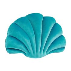 a blue scallop shaped pillow on a white background