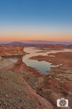 the sun is setting over lake powell in the desert