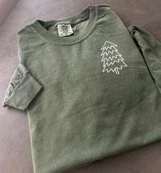 CANCELLATION CAN ONLY BE DONE BETWEEN 24 HOURS AFTER ORDERING  Emroidered tree shirt, embroidered Christmas tree, trendy Christmas tree These beautifully designed shirts and sweatshirts will make your day  a little extraordinary and meaningful.  Made out of good quality cotton and it feels so soft and nice. Please see our size chart and colors (available colors and sizes may vary, please reach us to find out currently available colors and sizes). The print colors are red, white and black, other Holiday Cotton Top With Embroidery, Holiday Cotton Embroidered Tops, Embroidered Christmas Sweatshirt, Christmas Tree Minimalist, Christmas Shirts Vinyl, Christmas Tree Outline, Embroidered Christmas Tree, Embroidered Tree, Tree Outline