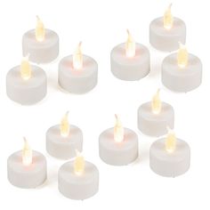 twelve white candles with yellow flame on each one are arranged in the shape of a circle