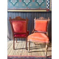 two chairs sitting next to each other on a wooden floor