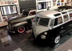 an old school bus and other cars are on display in a museum room with posters all over the wall