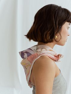 Introducing the ultimate versatile accessory, "The Dreamer" bandana silk scarf. This unique silk scarf showcases a mesmerizing pattern of flowers and treasures that evokes the ethereal and mysterious essence of the fictional worlds. It's a portal to another dimension, transporting you to an enchanted world where anything is possible.  This silk scarf is the perfect accessory to complement any outfit, adding a touch of bohemian chic to your look. Wear it as a headband, wrap it around your neck, o Bandana Silk, Headband Wrap, Silk Neck Scarf, Silk Bandana, Another Dimension, Scarf Top, Pink Scarves, Conscious Fashion, How To Wear Scarves