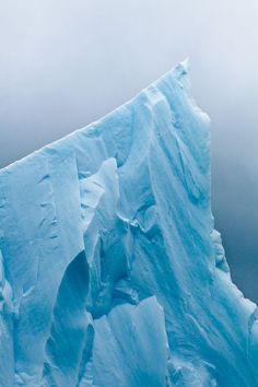 an iceberg in the ocean with snow on it