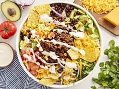 a large bowl filled with taco salad and toppings