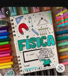 there is a notebook with the words fisca on it next to many crayons