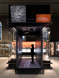 a person standing in front of a glass display case