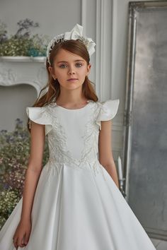 Indulge your little angel in designer style with this beautiful girls' dress by MB boutique. Ruffle detailing over both shoulders adds sweetness to this traditional white satin dress. Embellished with beads & sequins, the feather-like appliques provide special attention to this lovely gown. Mischka Aoki, White Satin Dress, Communion Cakes, First Communion Dress, First Communion Dresses, Communion Dresses, Flowing Dresses, Gala Dresses, Little Angel