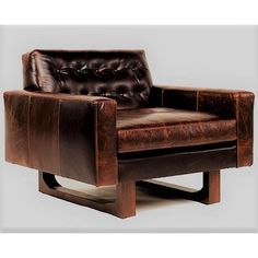 a brown leather chair sitting on top of a wooden frame