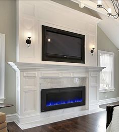 a living room with a fireplace and tv mounted on the wall above it's mantle