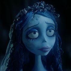 an animated corpse girl with blue hair and big eyes looks at the camera while wearing a tiara