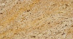 a close up view of the surface of a granite countertop with yellow and brown speckles