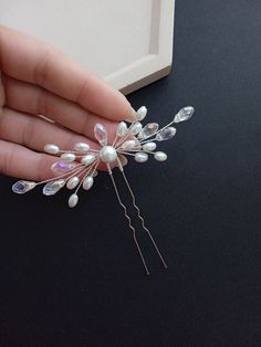 Elevate your bridal look with our exquisite crystal rhinestone and pearl wedding hair pin. This versatile accessory is designed to complement ANY hairstyle, adding a touch of glamour to your special day. * Stunning crystal rhinestones and lustrous pearls create a timeless and sophisticated look. * Versatility that enhances any hairstyle, ensuring you look your best from every angle. * Approximately 4 inches wide for a statement-making yet delicate finishing touch. Make your wedding day unforgettable with this elegant bridal hair pin. Order now to add a touch of sparkle and sophistication to your bridal ensemble! * All orders from the Exclusive Wedding Shop you will receive in a FREE beautiful gift box. * Standard shipping: - USA: 12-15 business days - Europe: 3-5 weeks - Canada: 6-10 weeks Hair Pieces For Wedding, Bridal Head Pieces, Pearl Hair Pin, Pearl Hair Pin Wedding, Wedding Hair Pin, Bridal Hair Pins Pearl, Diy Hair Accessories Ribbon, Bridal Hair Pin, Bead Hair Accessories