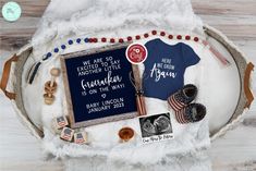 an image of a baby announcement with shoes and other items on the back of it