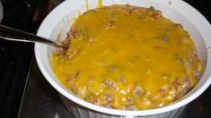 a white bowl filled with food sitting on top of a stove