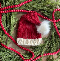 Hand-knit chunky Santa hat for infant with plenty of stretch. Perfect prop for baby Christmas photos. Perfect gift for baby's first Christmas. This piece is made to last so it can be an heirloom that is worn and passed down year after year.  Please feel free to reach out to me with any questions!  DETAILS: -One size fits most infants (newborn up to 18 months or so) -100% handmade -hand wash in cold water SIZING: -6 inches across at the bottom laid flat  -includes plenty of stretch for a growing Baby Christmas Hat, Baby Santa Hat, Baby Santa, Baby Christmas Photos, Christmas Photo Props, Baby Christmas Outfit, Baby Christmas Gifts, Santa Baby, Christmas Photo