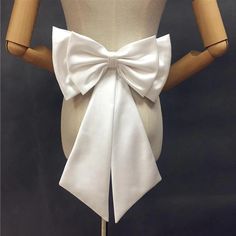 a mannequin wearing a white bow tie