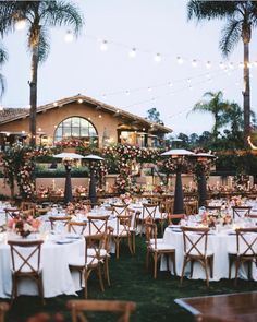 an outdoor dining area with tables, chairs and umbrellas