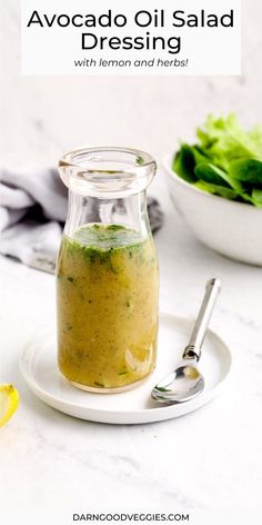 a glass jar filled with dressing next to a salad