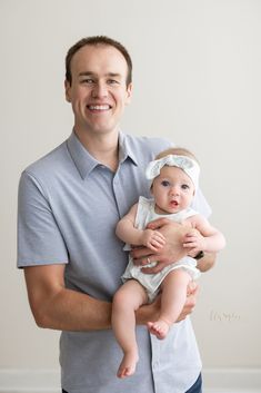 a man holding a baby in his arms